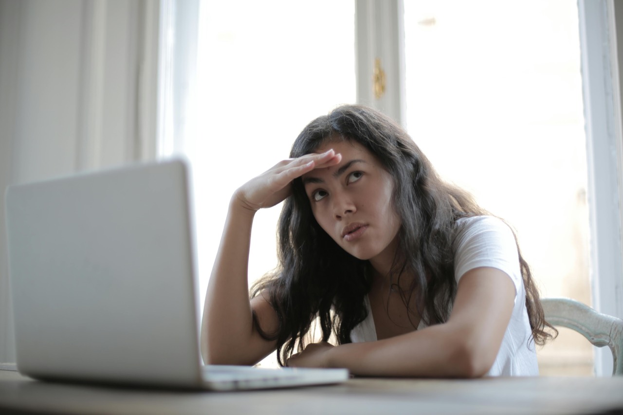 Woman playing games on laptop while relaxing